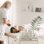 A serene spa setting featuring a facial treatment with a professional beautician, highlighting relaxation and skincare.